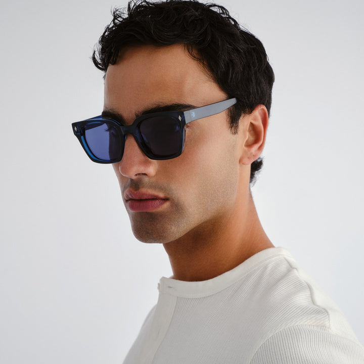 Man wearing dark blue Kingscliff  sunglasses with a neutral background