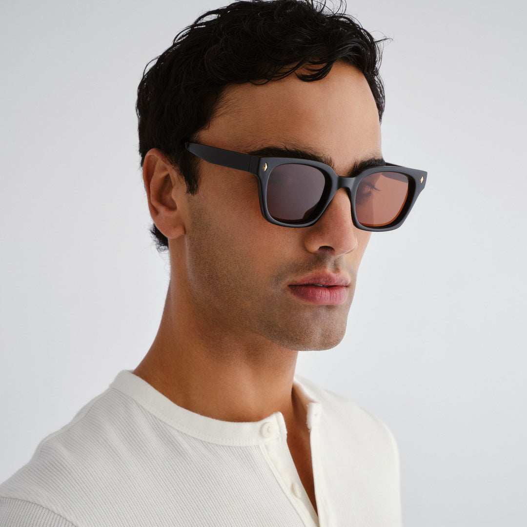 Man wearing dark Kingscliff sunglasses with a neutral background