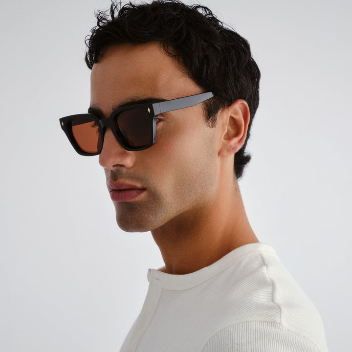 Man wearing Kingscliff sunglasses with a neutral background