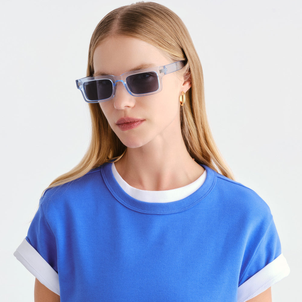 Female model wearing Austinmer Sunglasses in Ice Blue, front facing 