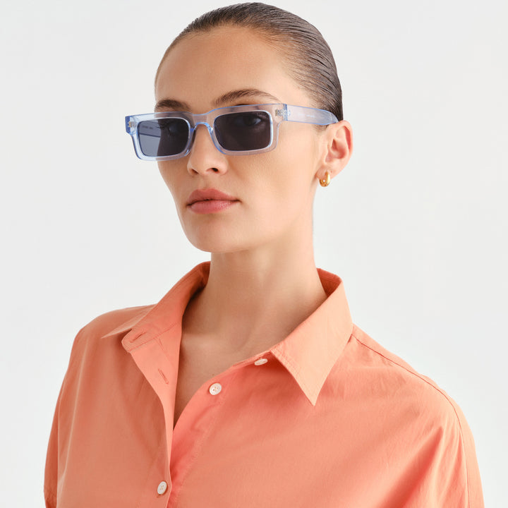 Woman wearing light blue rectangle sunglasses