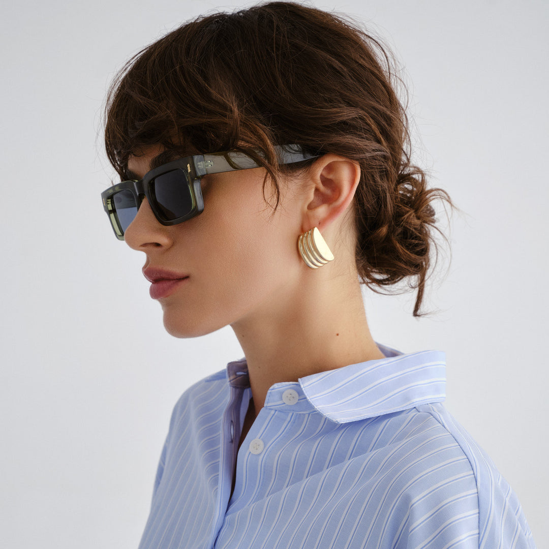 Female model wearing Austinmer Sunglasses in Khaki, side angle 