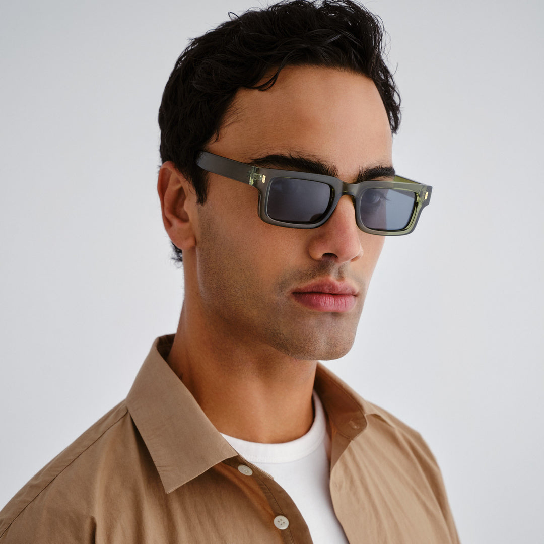 Male model wearing Austinmer Sunglasses sunglasses in khaki, front view showcasing fit and frame style