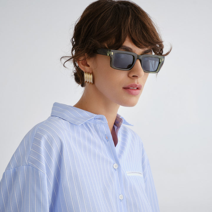 Female wearing Austinmer Sunglasses sunglasses in khaki, front view showcasing fit and frame style