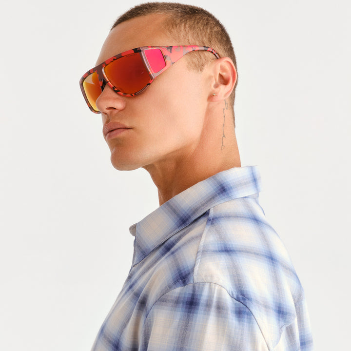 Man wearing 4 lens sunglasses with red and brown camo pattern