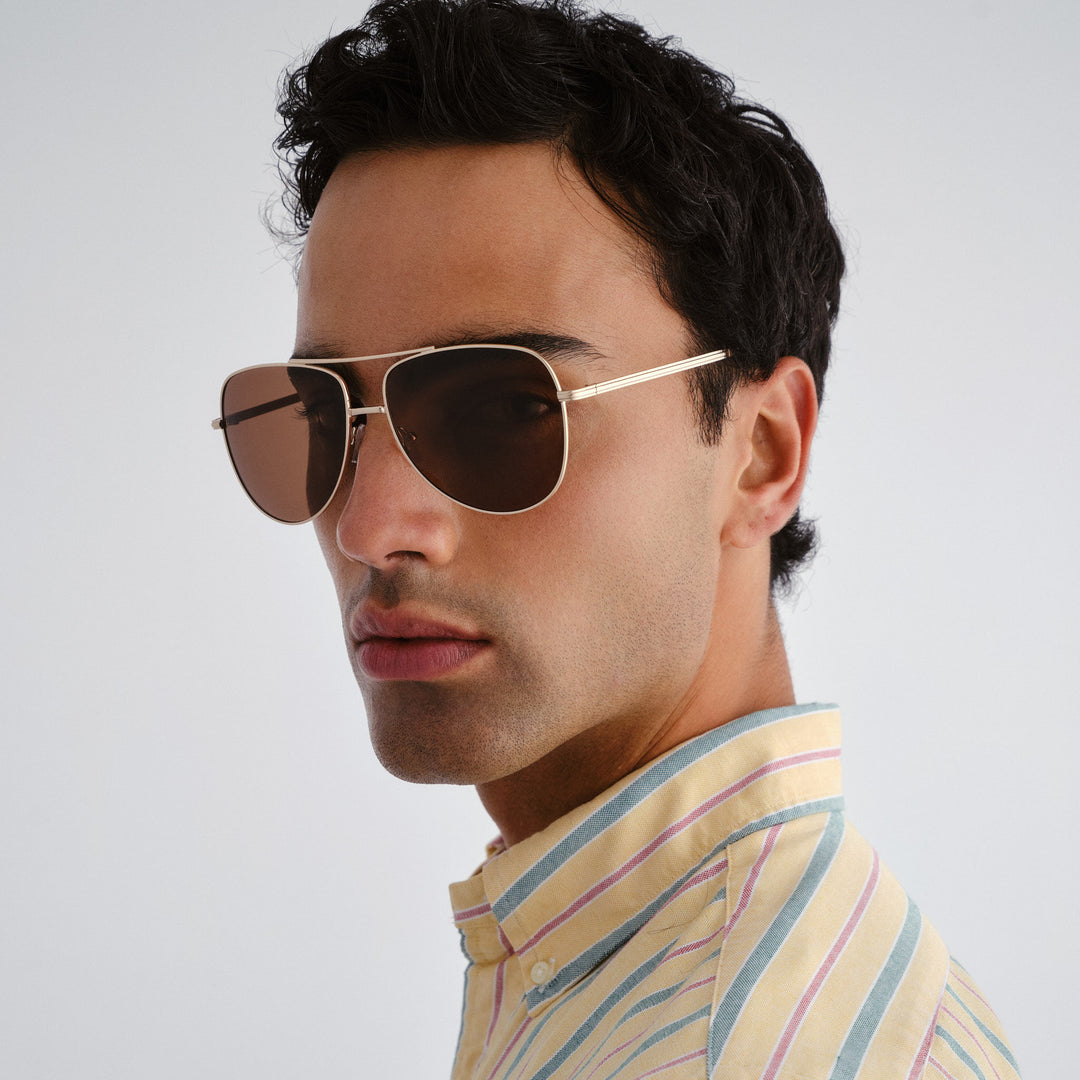 Man wearing sunglasses with a neutral background