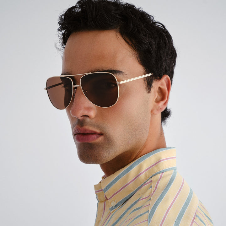 Man wearing sunglasses with a neutral background