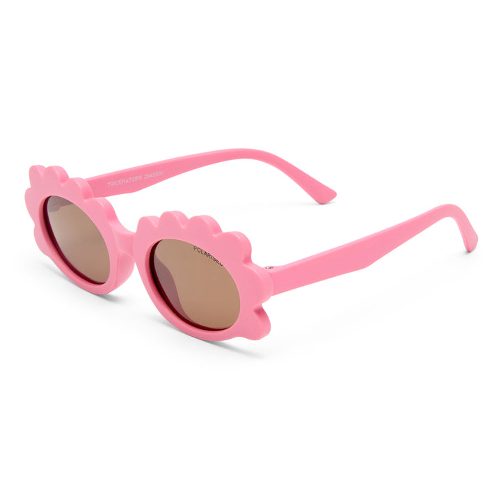 Triceratops kids sunglasses in matte pink, angled view highlighting playful frame design and temples