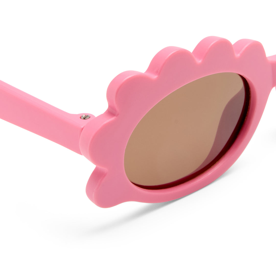 Triceratops kids sunglasses in matte pink, close-up detail of frame and temple showing smooth matte finish