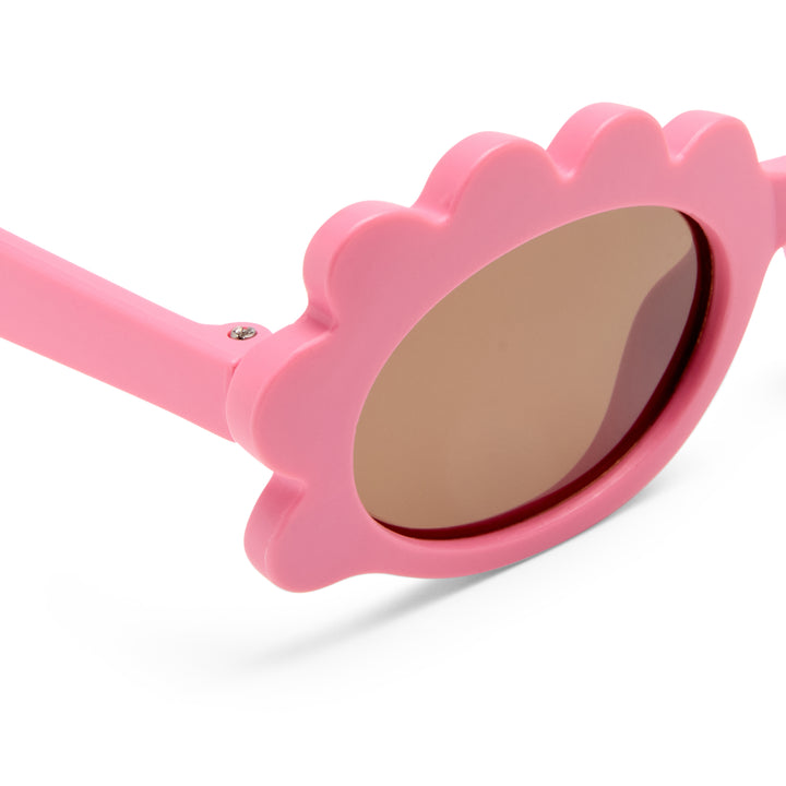 Triceratops kids sunglasses in matte pink, close-up detail of frame and temple showing smooth matte finish