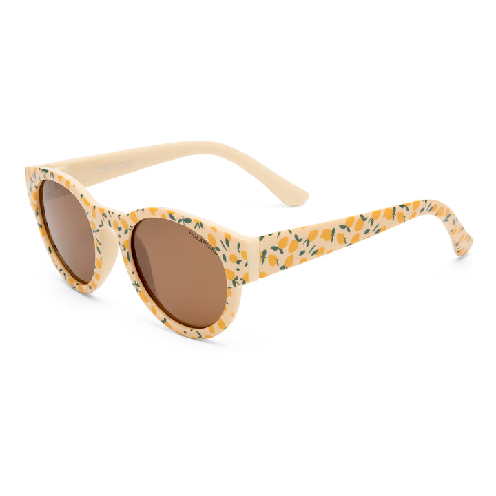 Three‑quarter angle of Magpie kids sunglasses in Lemon Print design