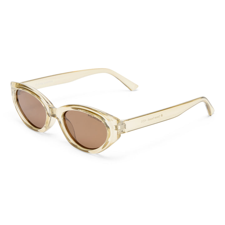 Cat-eye sunglasses with beige frame and brown lenses on a white background