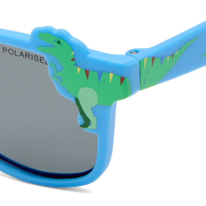 Close-up of blue children's sunglasses with a green dinosaur decoration on the frame and gray lenses. 