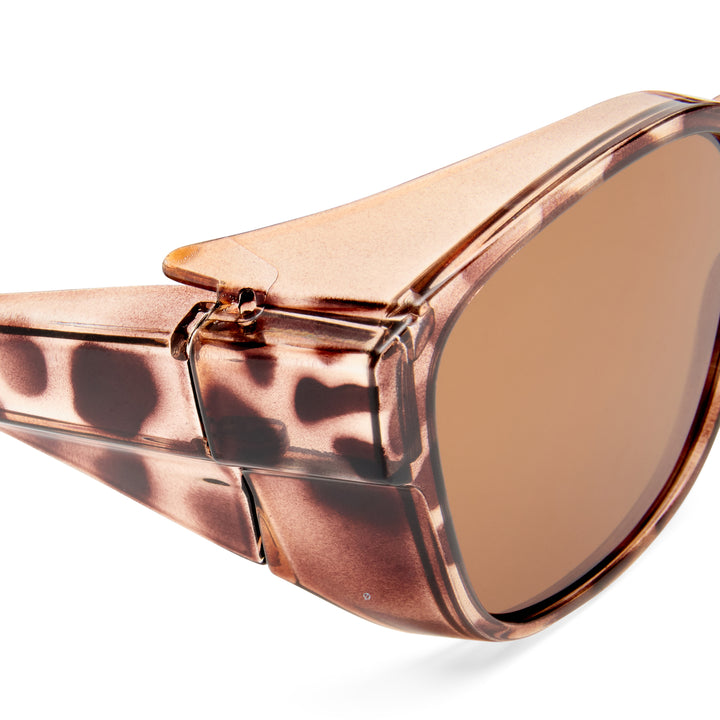 Close up of tortoiseshell sunglasses with brown lens on a white background